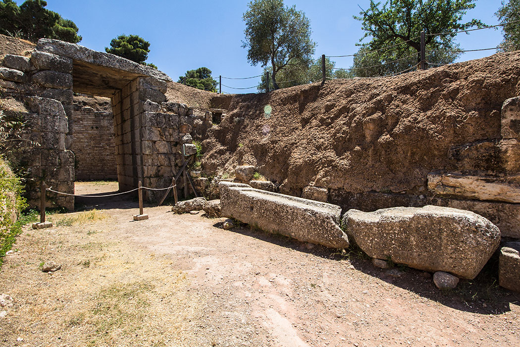 Mycenae argolis lions grave tholos peleoponnes greece Das Löwengrab (1450 v. Chr.) liegt direkt unter dem Burgberg und dem Archäologischen Museum. Dromos und Fassade bestehen aus geglätteten Steinen, die Kuppel ist eingestürzt. 