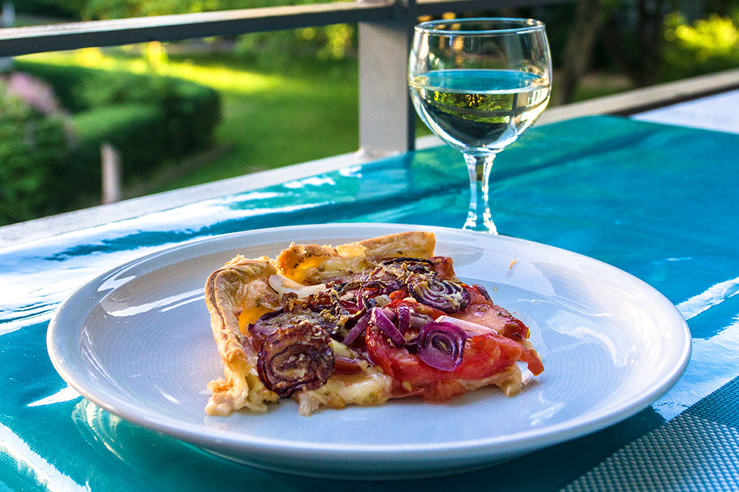 Blätterteig-Quiche mit Tomaten, Zwiebeln und Knoblauch - reise-zikaden.de - Ein perfekter Sommerabend im Freien! Mit einer fruchtigen Quiche mit Tomaten, dazu ein kühles Glas Weißwein.