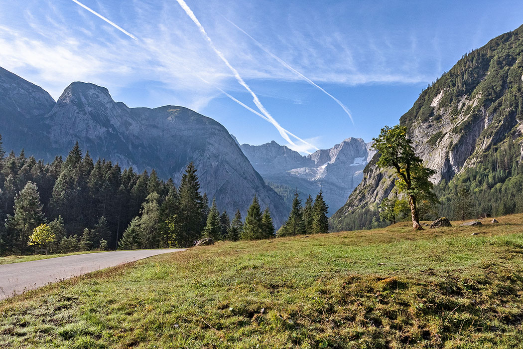 Tirol: Karwendel – Ausflug zum Ahornboden und der Eng Alm reise-zikaden.de, österreich, tirol, hinterriss, rissbach, oberer ahornboden, mautstrasse Gut ausgebaut ist die mautpflichtige Risser Landesstraße. Unser Standort ist das Obere Risstal mit Ahornen. Dahinter liegen Lamsenjochspitze und Spritzkarspitze. Diese Straße ist die einzige die ins Karwendel führt, die Gipfel sind nur über Forstwege und Bergpfade erreichbar. Foto: Reise-Zikaden, M. Hoffmann